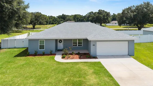 a view of a house with swimming pool and a yard