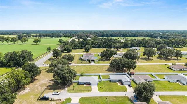 an aerial view of residential houses with outdoor space and swimming pool