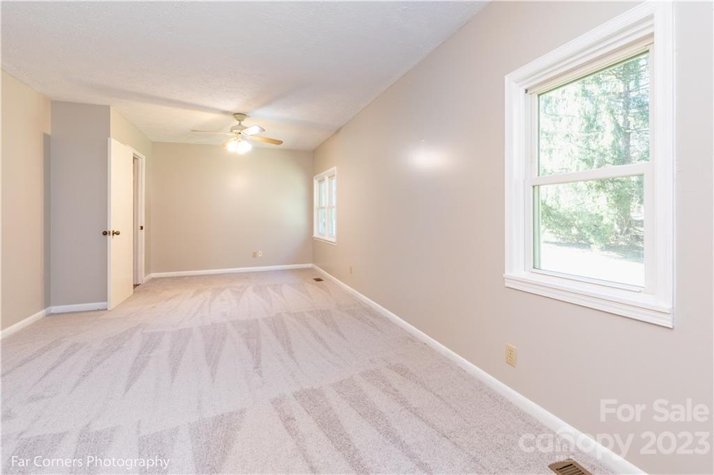 8 Ross Farm Road Waynesville, NC 28786 - Photo 11 of 23 an empty room with wooden floor and windows