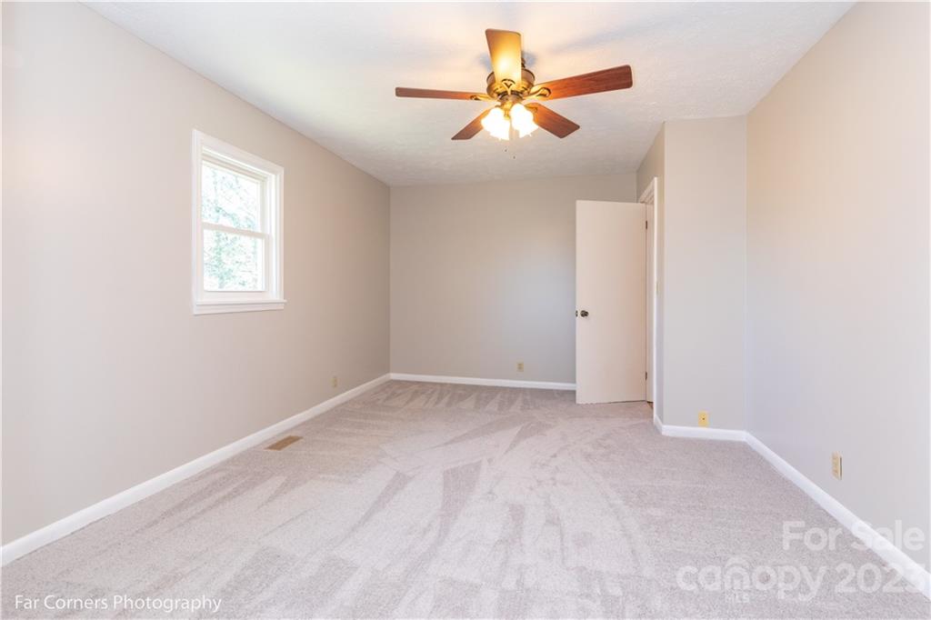 8 Ross Farm Road Waynesville, NC 28786 - Photo 13 of 23 an empty room with a window and a fan