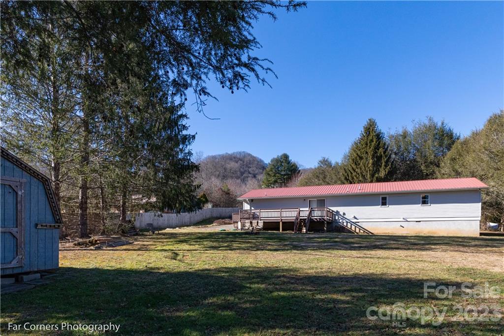 8 Ross Farm Road Waynesville, NC 28786 - Photo 19 of 23 a view of a large pool with lawn chairs under an umbrella