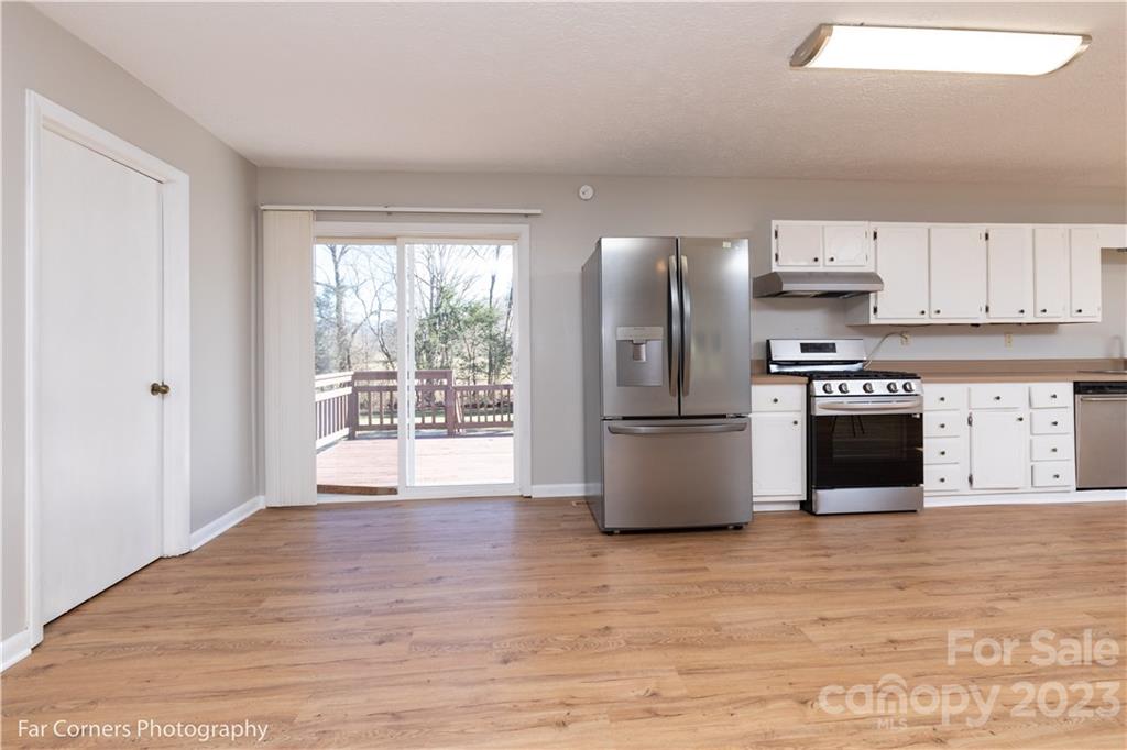 8 Ross Farm Road Waynesville, NC 28786 - Photo 7 of 23 a kitchen with stainless steel appliances granite countertop a stove a refrigerator and a microwave
