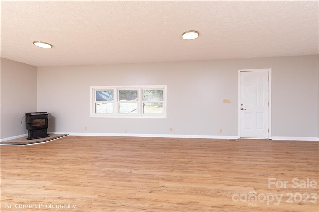 8 Ross Farm Road Waynesville, NC 28786 - Photo 8 of 23 a view of an empty room with window and wooden floor