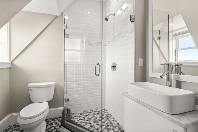 a bathroom with a toilet and a shower