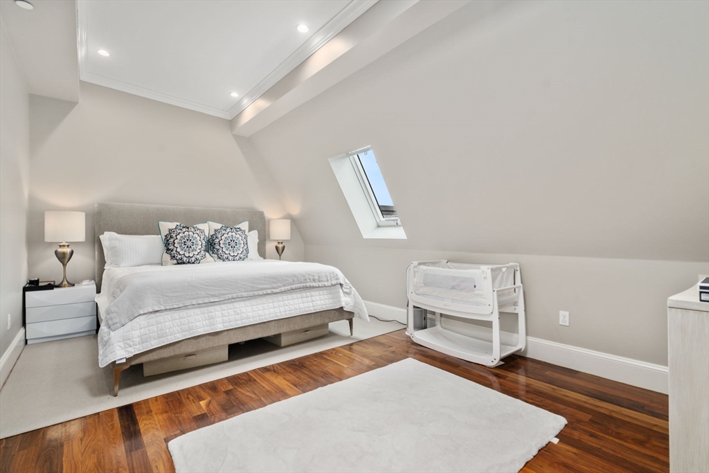 324 Tappan Street, Unit 2 Brookline, MA 02445 - Photo 13 of 19 a bedroom with a bed and wooden floor