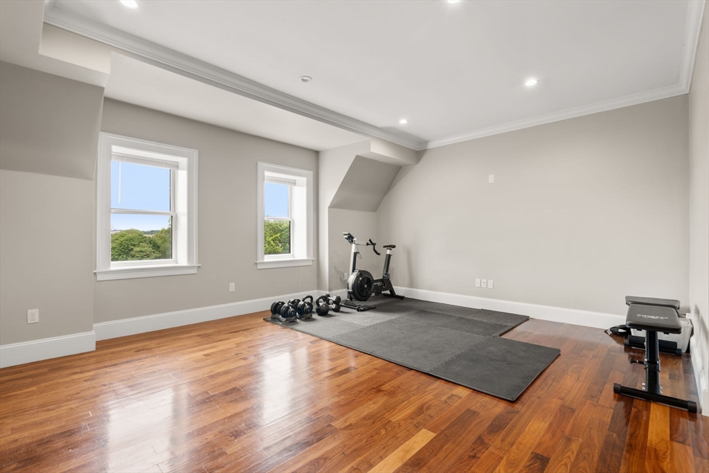 324 Tappan Street, Unit 2 Brookline, MA 02445 - Photo 6 of 19 wooden floor in an empty room with a window