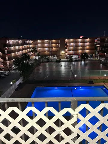 a view of a pool an outdoor space and sitting space