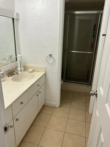 a bathroom with a double vanity sink and mirror