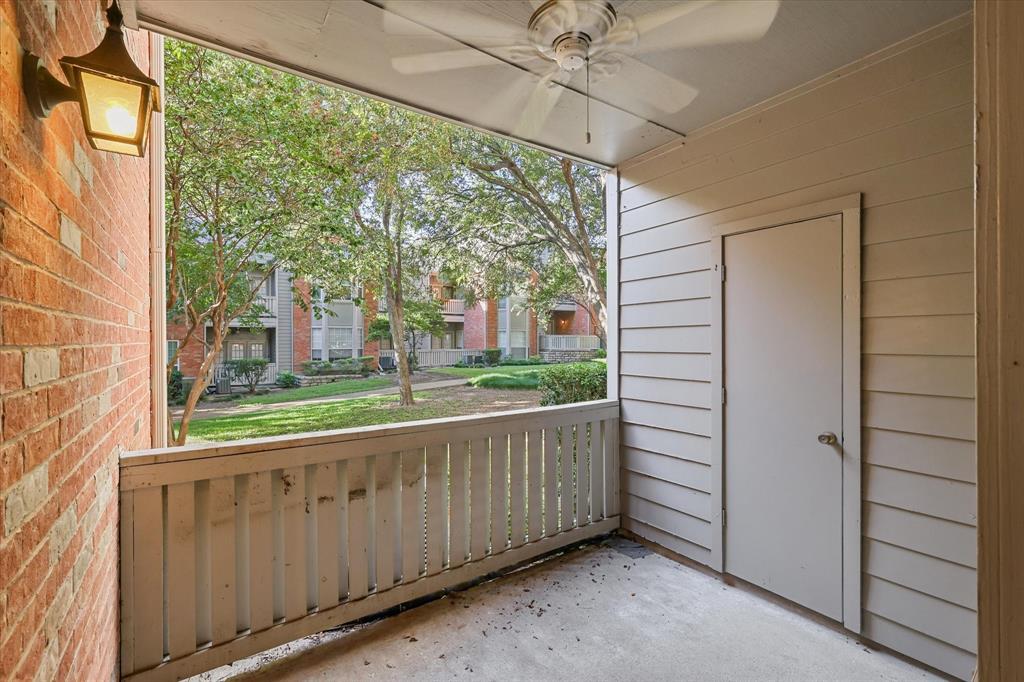 12660 Hillcrest Road, Unit 7103 Dallas, TX 75230 - Photo 11 of 14 a view of a porch with wooden floor and front door
