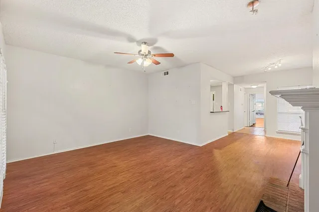 a view of an empty room with a kitchen
