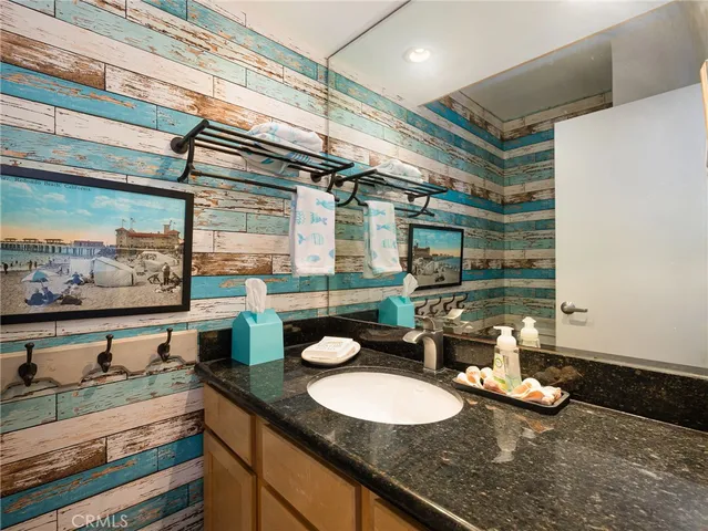 a bathroom with a sink mirror and vanity