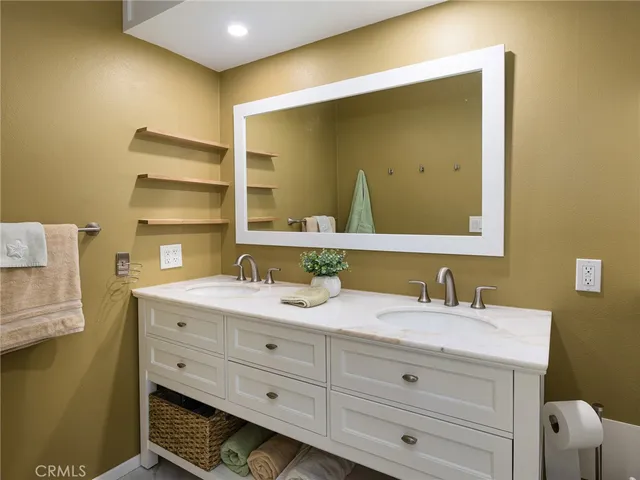 a bathroom with a double vanity sink and a mirror