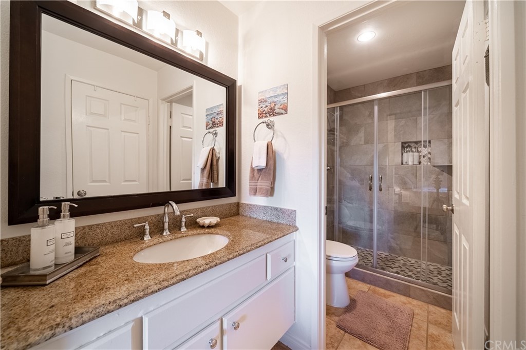26 Corniche Drive, Unit F Dana Point, CA 92629 - Photo 34 of 46 a bathroom with a granite countertop sink shower mirror and toilet