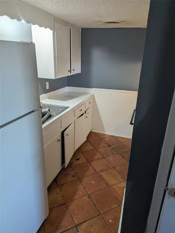 a utility room with cabinets washer and dryer