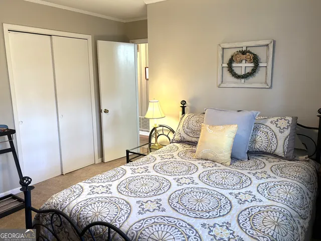 a bedroom with a bed and a bookshelf