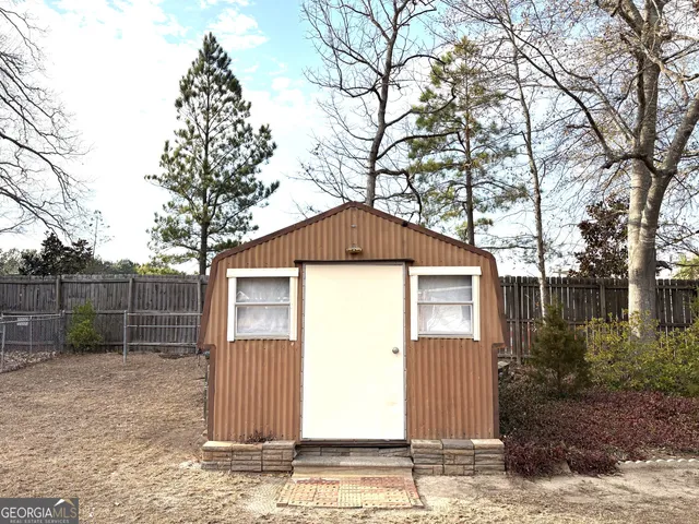 a backyard of a house with lots of green space and trees