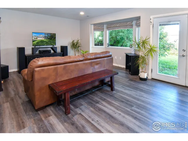 a bed room with wooden floor and a window