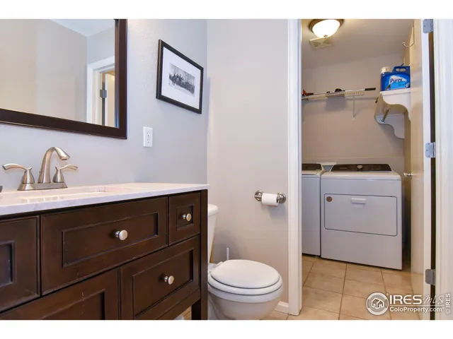 a bathroom with a sink vanity and toilet