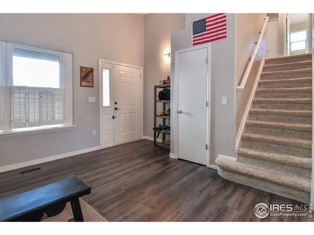 a view of an entryway with wooden floor