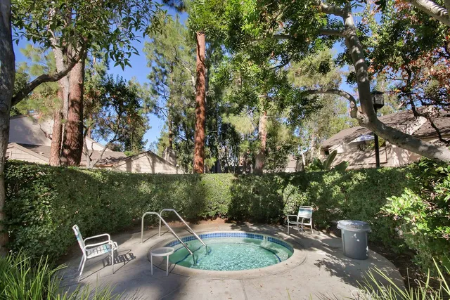 a swimming pool with outdoor seating and yard