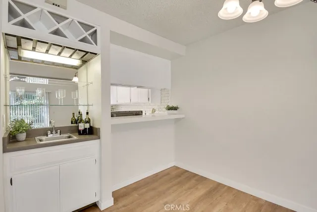 a room with a white wall and sink