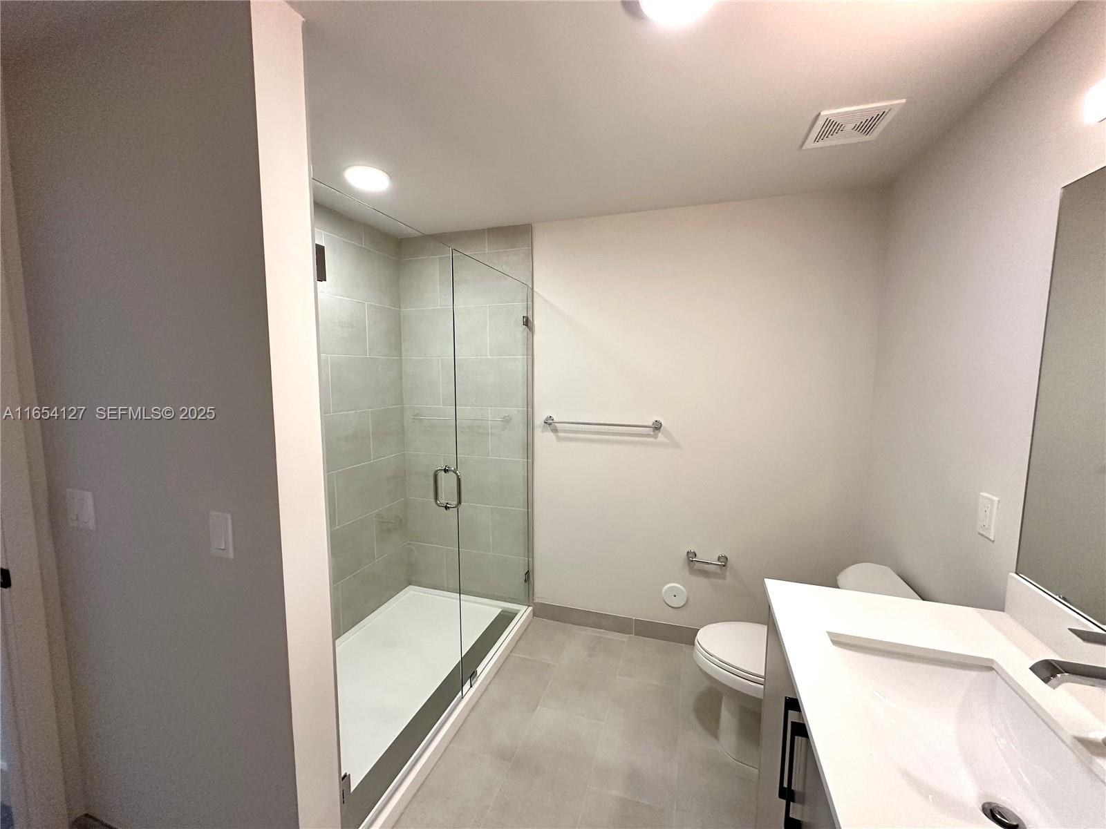 18412 Homestead Avenue, Unit 727 Miami, FL 33157 - Photo 11 of 24 a bathroom with a tub and a toilet