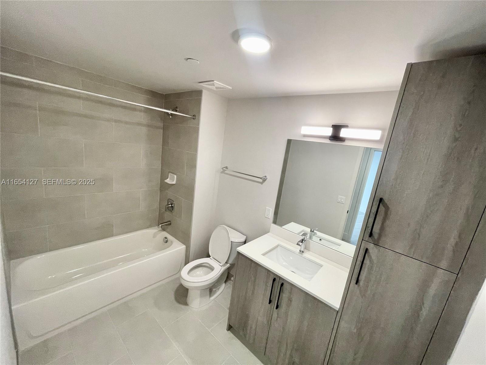 18412 Homestead Avenue, Unit 727 Miami, FL 33157 - Photo 13 of 24 a bathroom with a sink toilet and shower