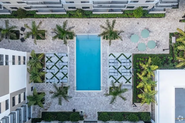 a view of a living room and kitchen with furniture