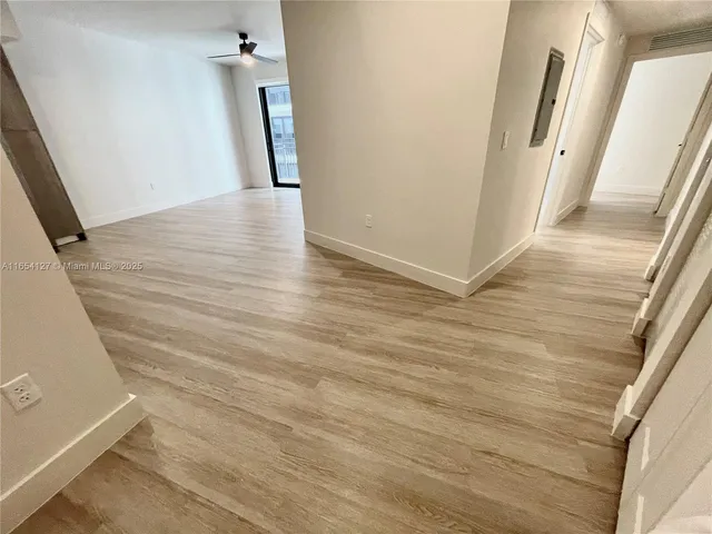 a view of a kitchen with a sink and a refrigerator