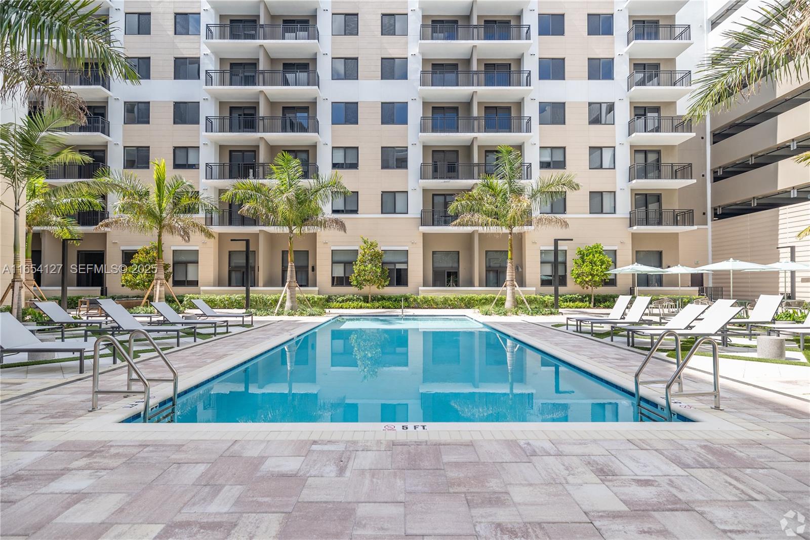 18412 Homestead Avenue, Unit 727 Miami, FL 33157 - Photo 4 of 24 a swimming pool view with a outdoor seating
