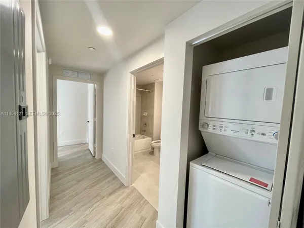 a view of hallway with wooden floor