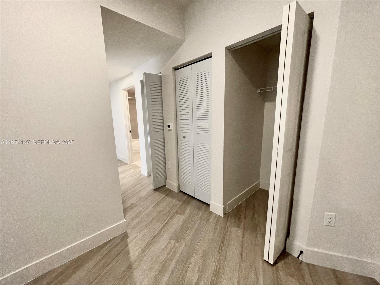 18412 Homestead Avenue, Unit 727 Miami, FL 33157 - Photo 6 of 24 a view of hallway with wooden floor