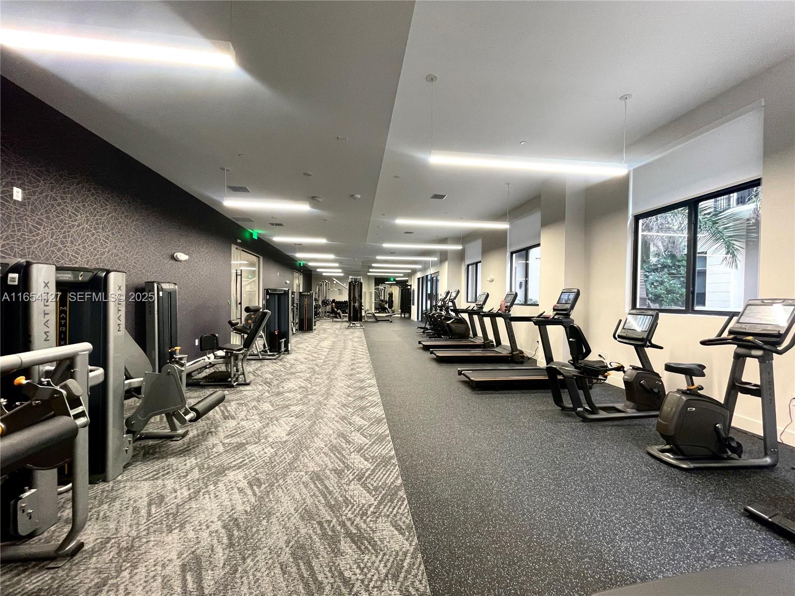 18412 Homestead Avenue, Unit 727 Miami, FL 33157 - Photo 9 of 24 a view of a room with gym equipment