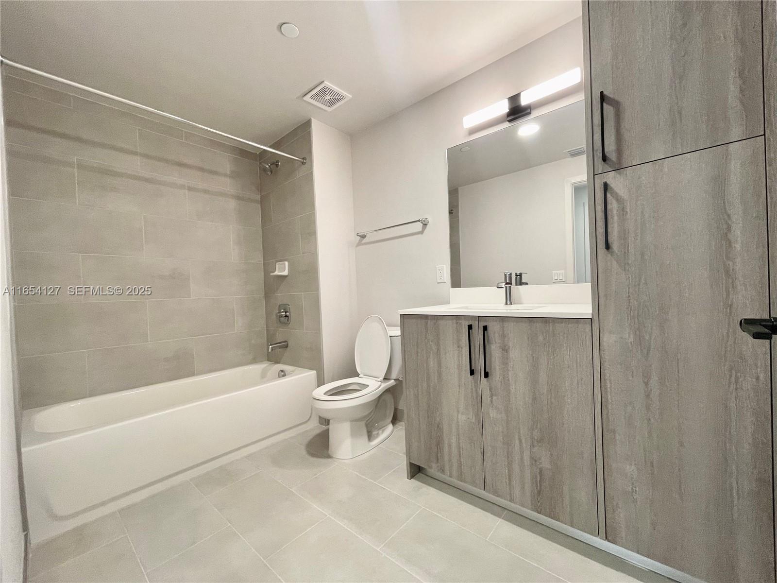 18412 Homestead Avenue, Unit 727 Miami, FL 33157 - Photo 10 of 24 a bathroom with a sink a toilet and shower