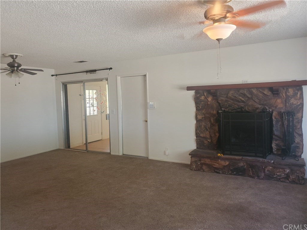 13020 Pawnee Road Apple Valley, CA 92308 - Photo 10 of 14 Firplace in living room, dining area and enclosed patio. Door is direct access garage