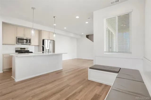 a view of kitchen with sink microwave and cabinets