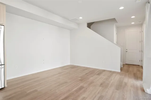 a view of hallway with wooden floor