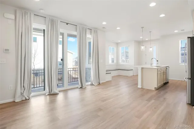 a view of a big room with wooden floor and windows