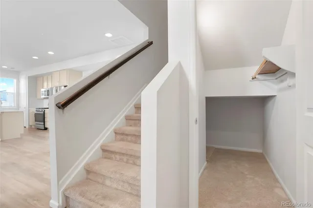 a view of entryway and hall with wooden floor
