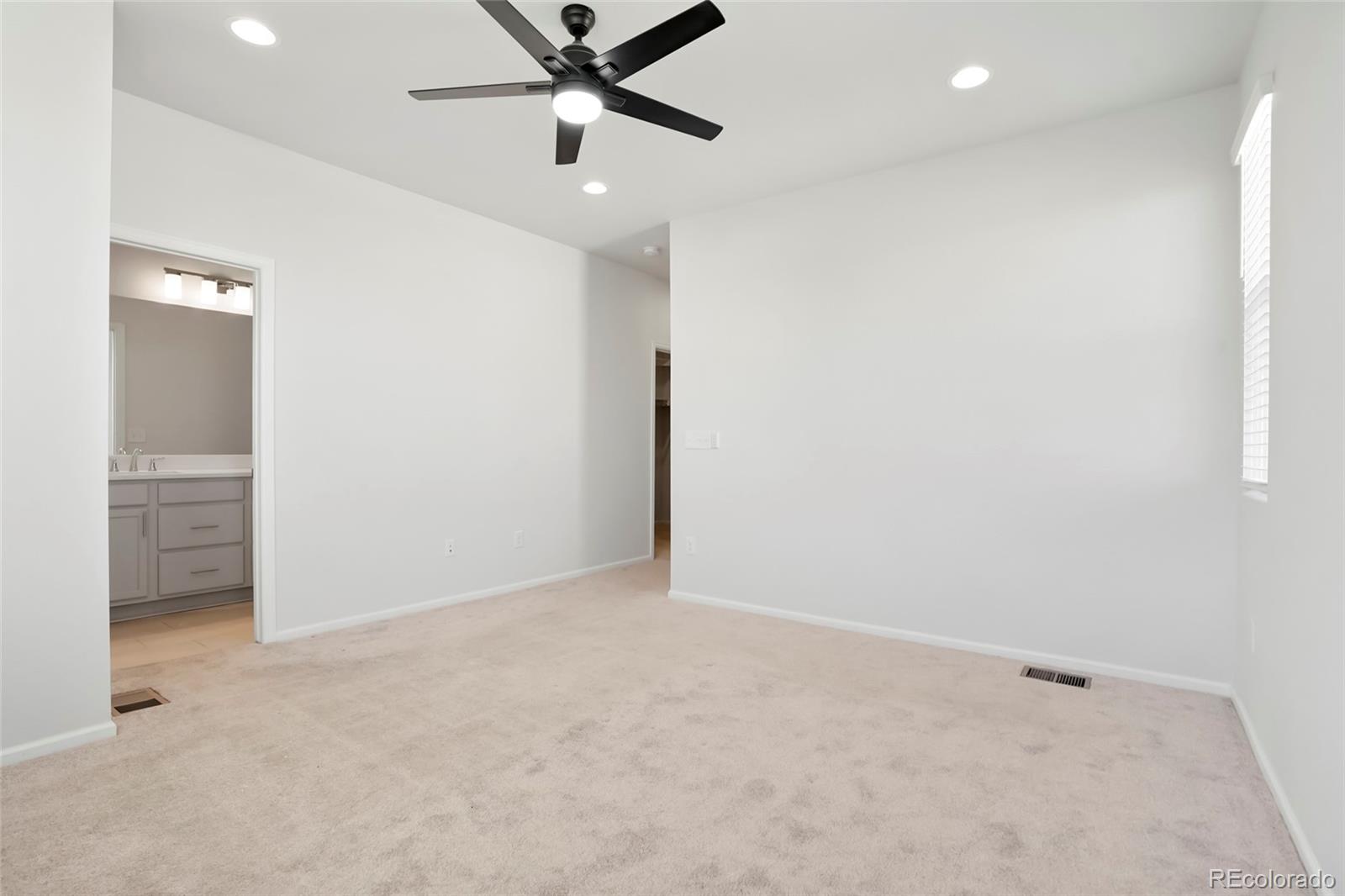 1675 South Andes Way Aurora, CO 80017 - Photo 25 of 32 an empty room with closet and fan