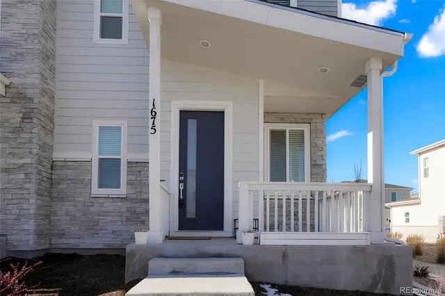 a view of a house with a small deck