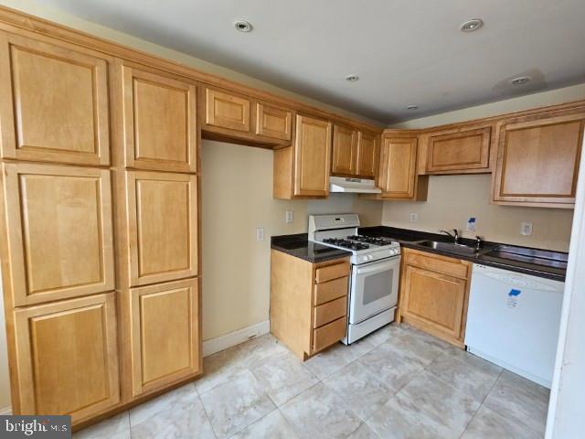 8509 Temple Road Philadelphia, PA 19150 - Photo 6 of 16 a kitchen with granite countertop stainless steel appliances a refrigerator a stove top oven and cabinets