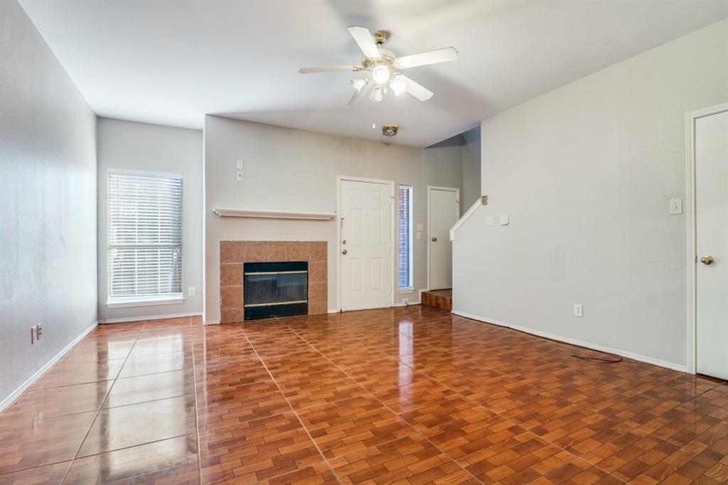 3817 Brandon Park Drive Garland, TX 75044 - Photo 2 of 11 wooden floor fireplace and windows in an empty room
