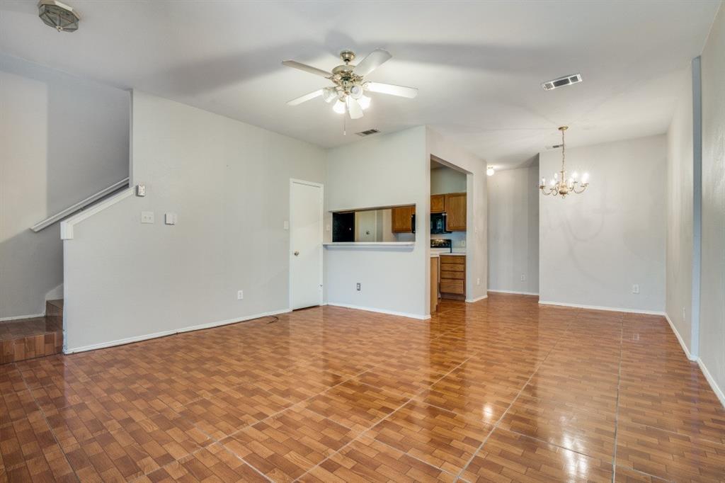 3817 Brandon Park Drive Garland, TX 75044 - Photo 3 of 11 an empty room with kitchen and chandelier fan