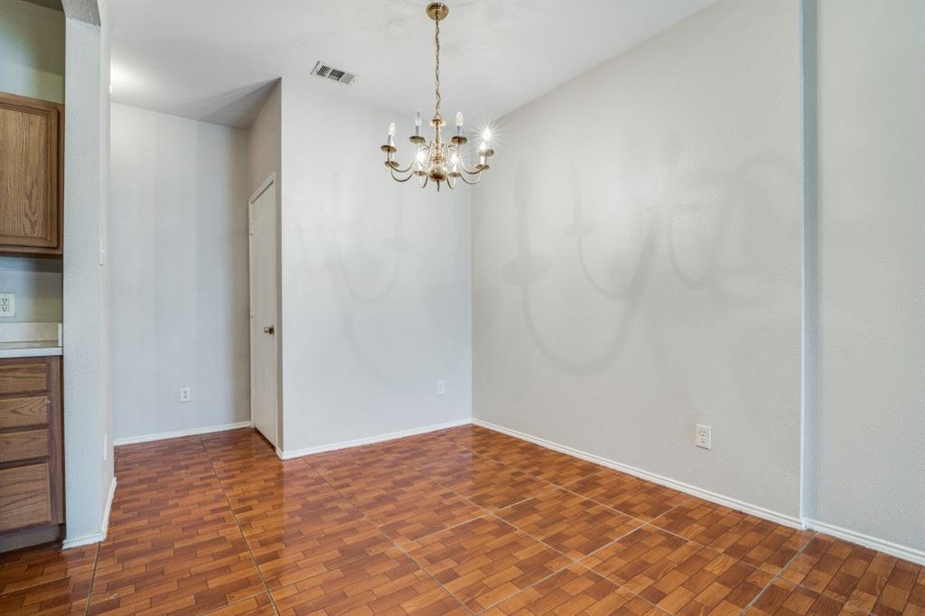 3817 Brandon Park Drive Garland, TX 75044 - Photo 4 of 11 a view of a room with wooden floor and chandelier
