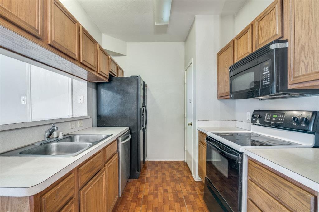 3817 Brandon Park Drive Garland, TX 75044 - Photo 5 of 11 a kitchen with stainless steel appliances granite countertop a sink stove and refrigerator