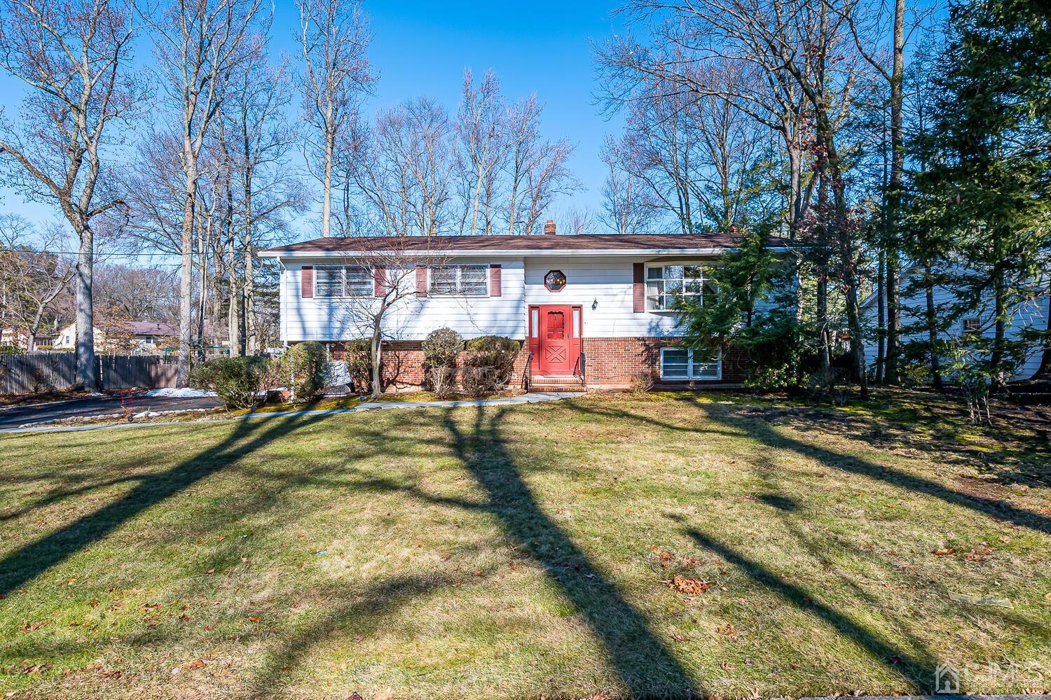 41 Clive Hills Road Edison, NJ 08820 - Photo 1 of 39 a view of swimming pool with large trees and a wooden fence