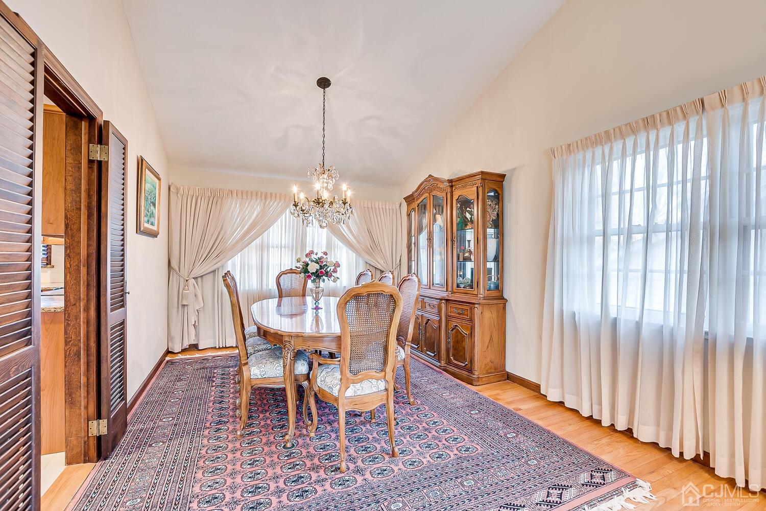 41 Clive Hills Road Edison, NJ 08820 - Photo 11 of 39 a dining room with furniture a chandelier and wooden floor