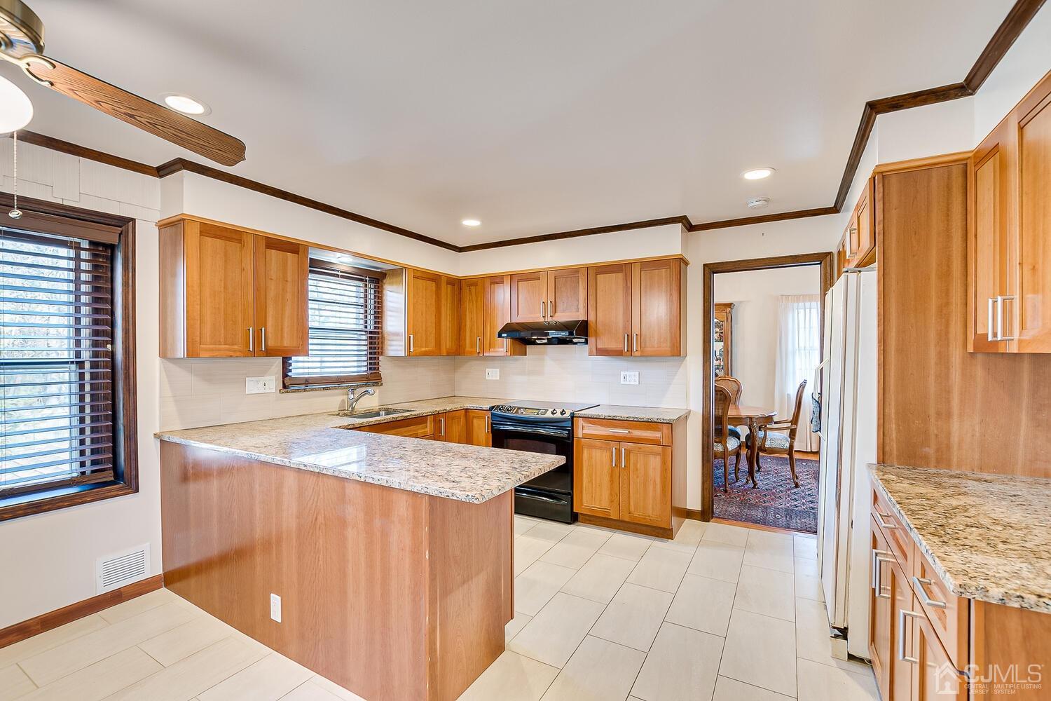 41 Clive Hills Road Edison, NJ 08820 - Photo 18 of 39 a kitchen with stainless steel appliances granite countertop a sink stove and refrigerator
