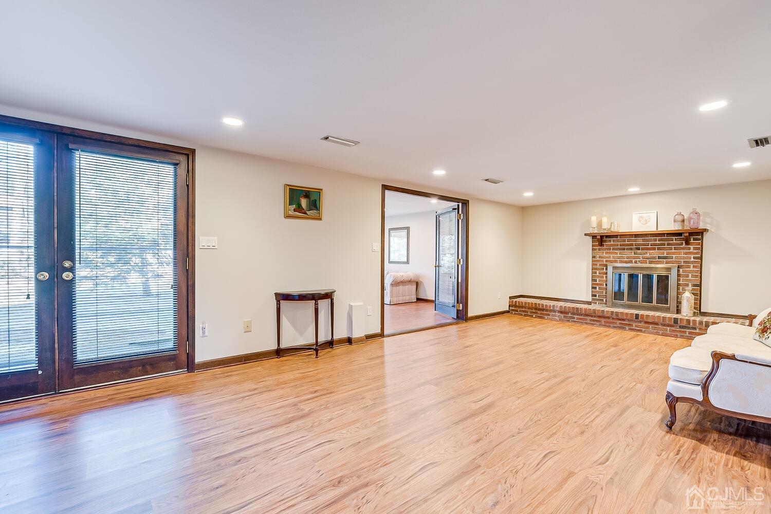 41 Clive Hills Road Edison, NJ 08820 - Photo 19 of 39 a view of empty room with wooden floor and fireplace